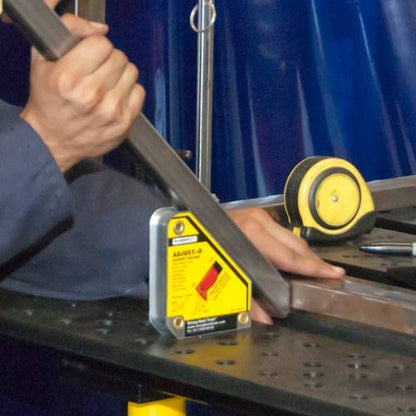 Strong Hand Tools MSA48-HD Heavy Duty Adjust-O Magnet Square in use, holding metal in place on a workbench for welding applications.